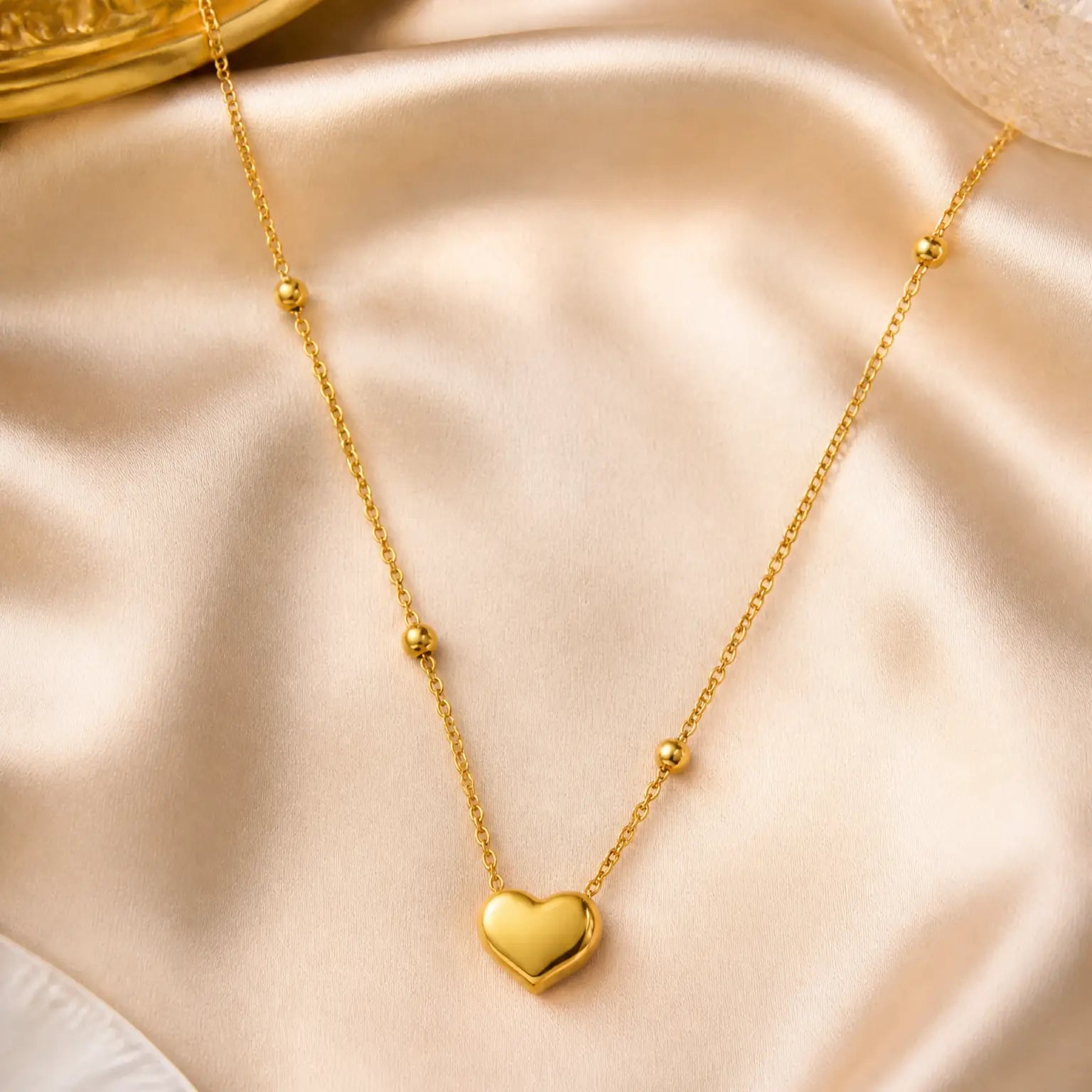 Anti-tarnish gold stainless steel beaded chain necklace with a smooth gold heart pendant.