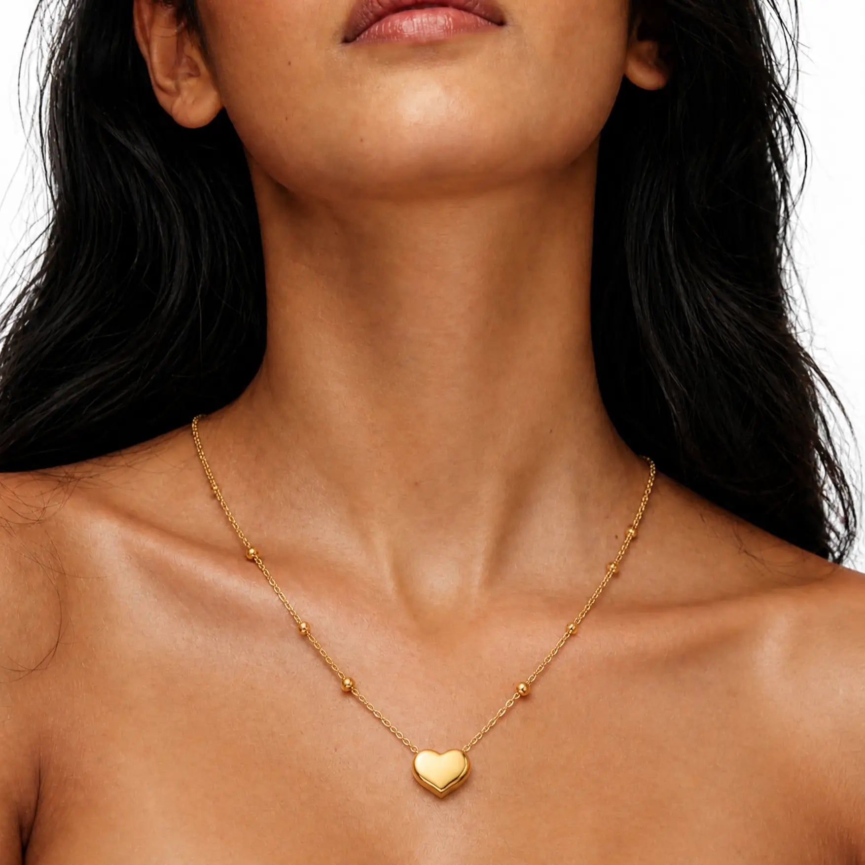 Anti-tarnish gold stainless steel beaded chain necklace with a smooth gold heart pendant.