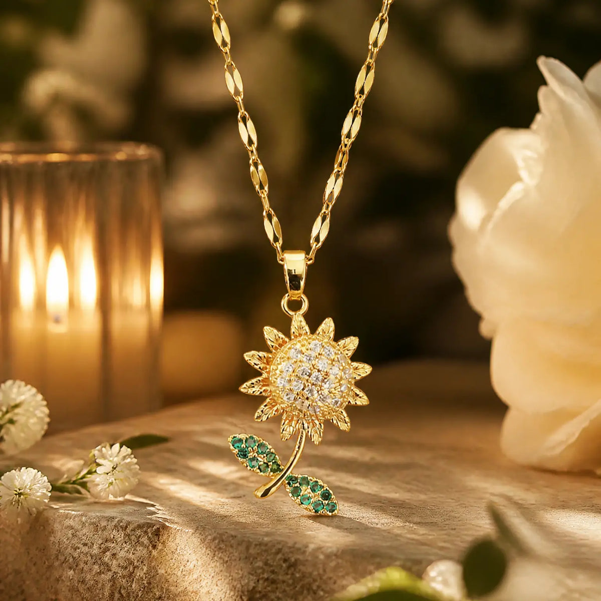 Anti-tarnish gold stainless steel sunflower necklace with clear pave crystals and green leaf detailing.