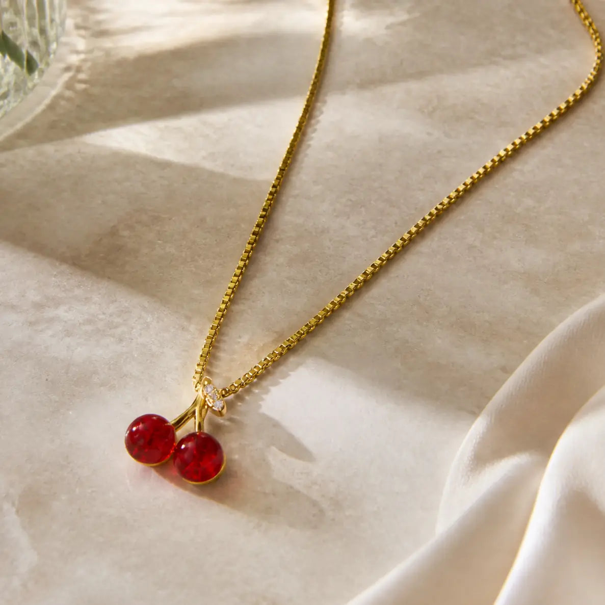 Anti-tarnish gold stainless steel box chain necklace with a red crystal cherry pendant.